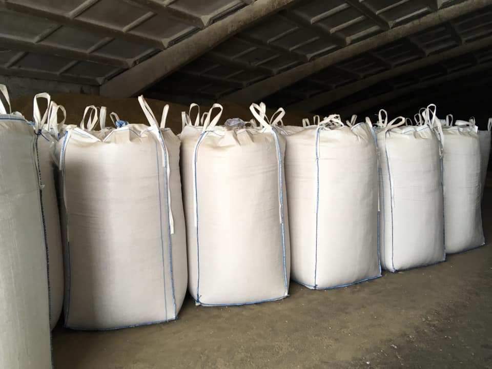 Rows of large bulk bags stored in a warehouse