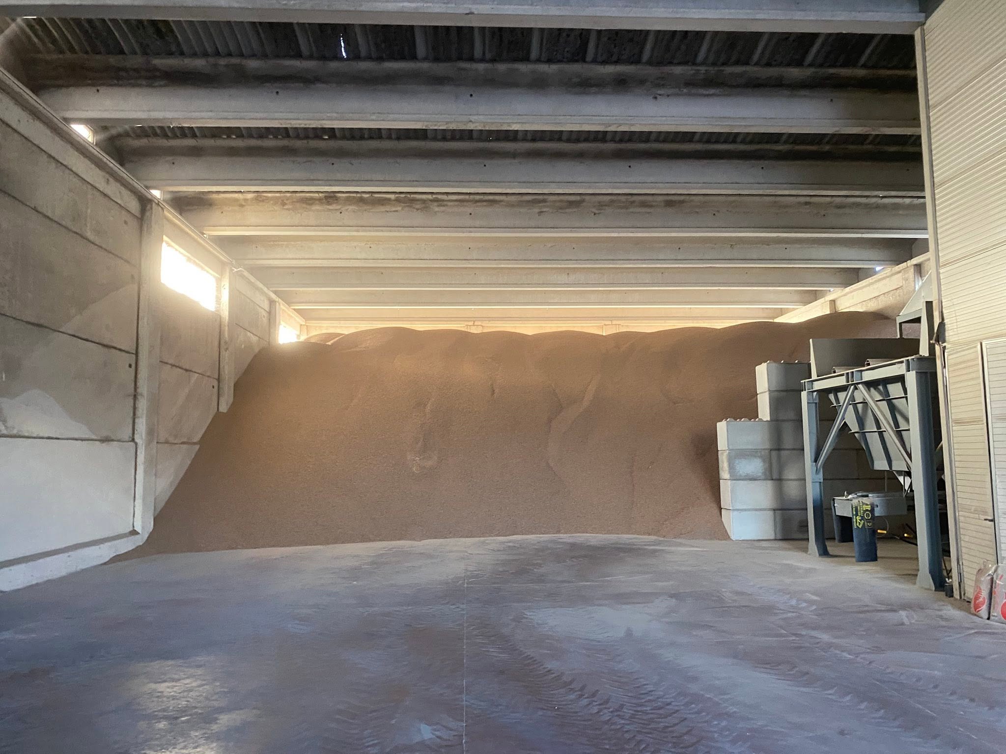 Bulk wood pellets stored inside a warehouse