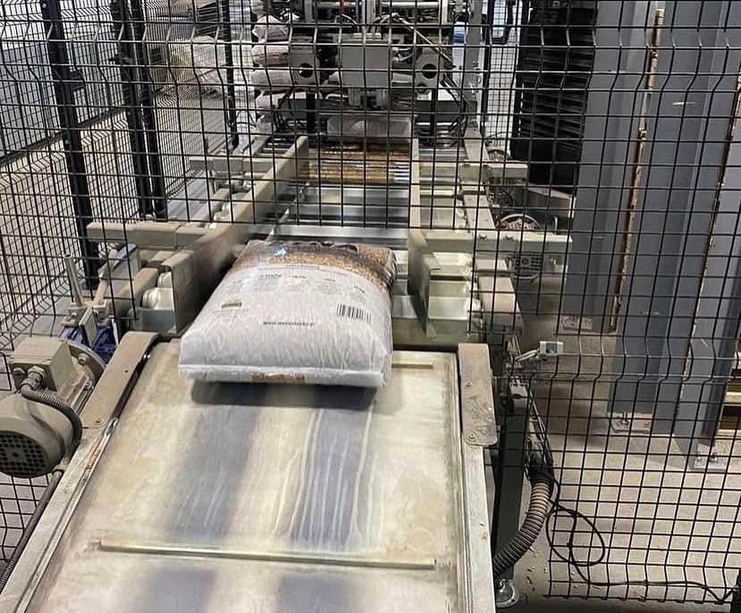 A filled pellet bag on an industrial packaging conveyor